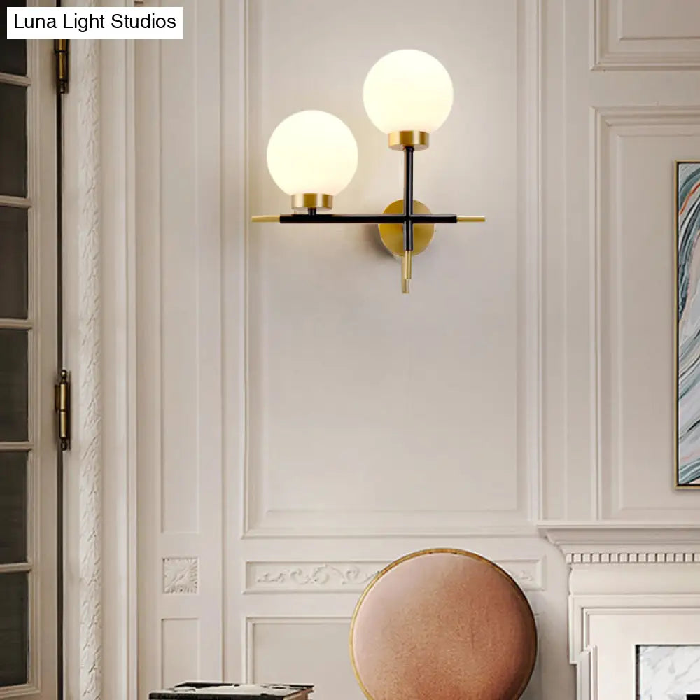Post-Modern White Glass Sphere Wall Sconce With Brass Finish - 1/2 Bulbs