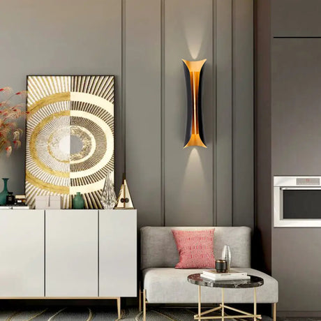 Modern curl wall sconce in black mounted on an interior wall