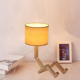 Modern Wood Man-Shaped Table Lamp With Book Rack And Cylinder Fabric Shade - Single