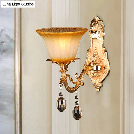 Amber Glass Wall Sconce With Brass Flower Detail For Traditional Bedroom Lighting