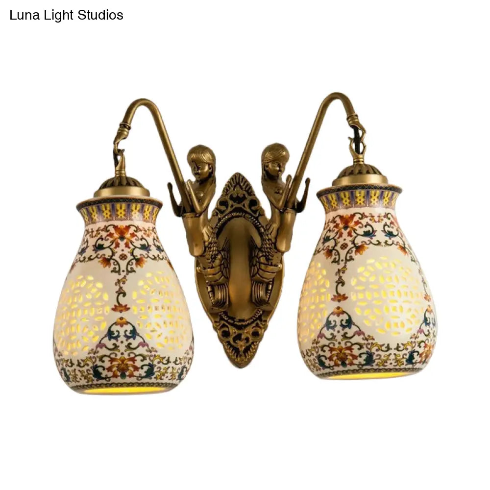Antique Brass Ceramic Wall Sconce With Pierced Jar Traditional Patterned Design And Small Mermaid