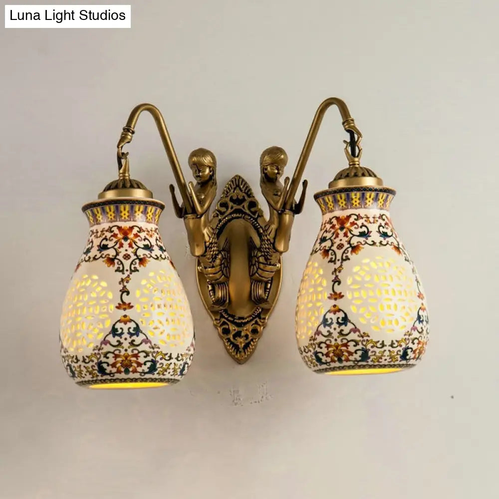 Antique Brass Ceramic Wall Sconce With Pierced Jar Traditional Patterned Design And Small Mermaid