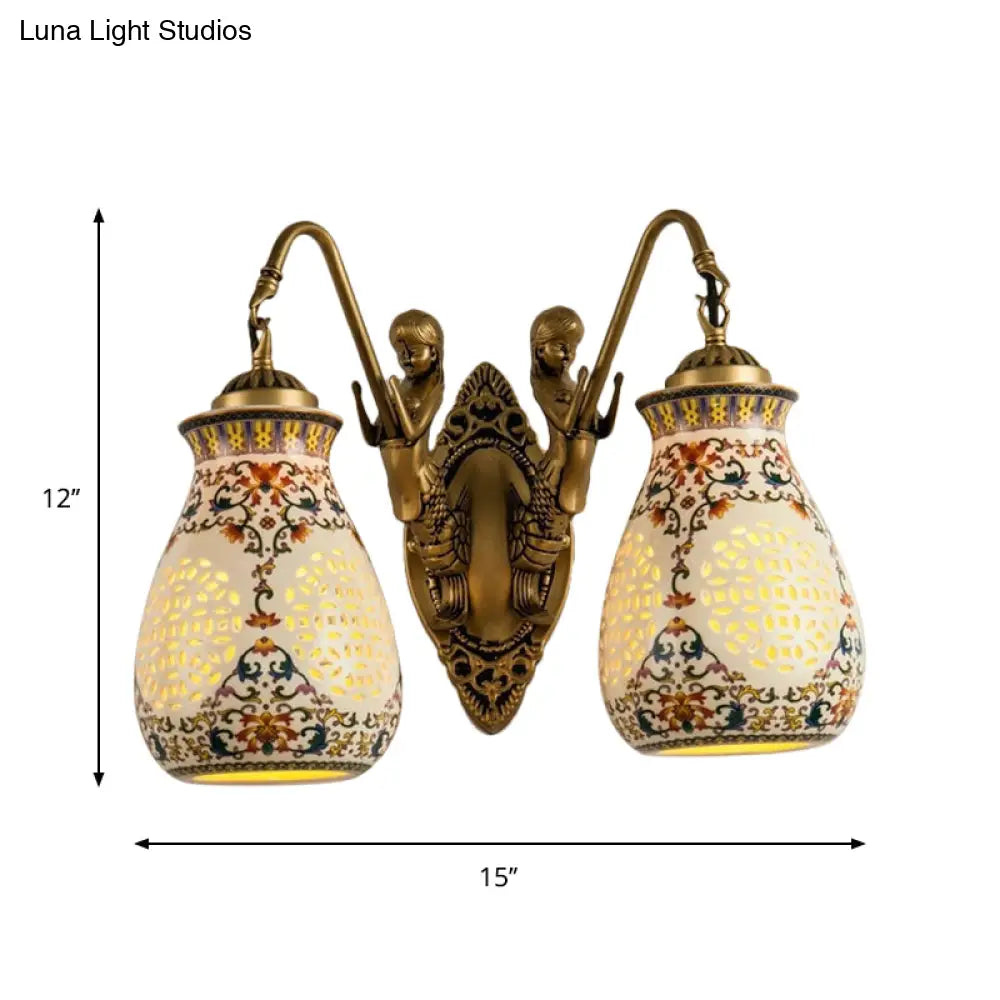Antique Brass Ceramic Wall Sconce With Pierced Jar Traditional Patterned Design And Small Mermaid