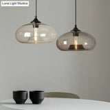 Black Glass Dining Pendant Light With Modern Ellipse Suspension - 1 Head Fixture