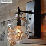 Black Skull Wall Mount Light Artistic Single-Bulb Clear Glass Sconce For Corridor