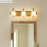 Brass Armed Wall Sconce With Ribbed Glass Shade For Bathroom Decoration