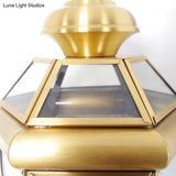 Brass Wall Sconce With Clear Glass Urn And Curved Arm Single Bulb Light Fixture