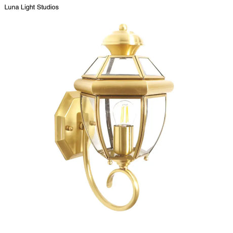 Brass Wall Sconce With Clear Glass Urn And Curved Arm Single Bulb Light Fixture