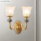 Classic Brass Floral Wall Sconce With Clear Ribbed Glass And Swooping Arm - 1/2-Head Mount Lamp