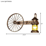 Coastal Brass Amber Glass Wall Sconce With Wagon Wheel Deco