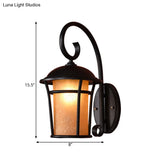 Country Black Finish Cylinder Wall Mounted Sconce With Seeded Glass And Swooping Arm