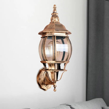 Country Outdoor Wall Light With Clear Glass Shade In Brass - 1 Bulb Fixture