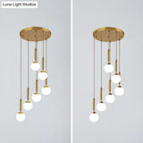 Gold Multi Hanging Stairway Light With Minimalist White Glass Ball Pendant