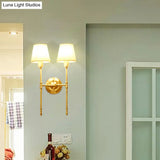Golden Fabric Wall Sconce With Elongated Arm For Simplistic Bedroom Lighting