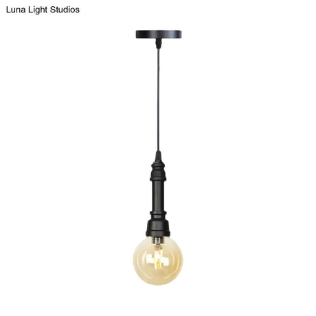 Industrial Black Finish Amber Glass Pendant Lamp With Pipe Suspension - 1-Light Ball/Capsule