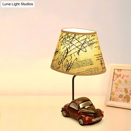 Kids Beige Barrel Night Table Lamp With Car Base - 1-Light Fabric Bedroom Nightstand Light
