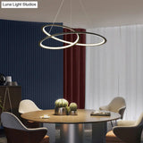 Metal Led Chandelier: Sleek Seamless Curves For Minimalistic Dining Room Lighting