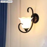 Milky Glass Wall Sconce With Floral Design And Scroll Arm For Elegant Country Decor