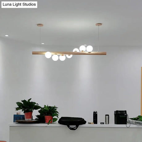 Minimalist Cream Glass Led Pendant Light For Restaurants - Ball Island Ceiling With Wood Accent