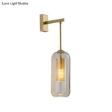 Modern 1-Head Gold Wall Mount Light For Bedside - Clear Glass Capsule Sconce Fixture