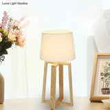 Modern Beige Trapezoid Nightstand Lamp With Wood Base And Tapered Fabric Shade