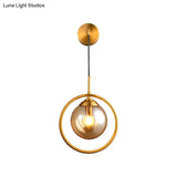 Modern Brass Wall Sconce With Glass Sphere Shade For Bedside Lighting