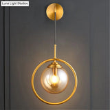 Modern Brass Wall Sconce With Glass Sphere Shade For Bedside Lighting
