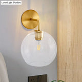 Modern Glass Orb Wall Sconce With Brass Arm Clear/White
