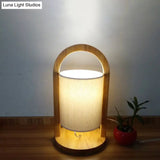 Modern White Cylindrical Nightstand Lamp With Wood Handle - Task Light Fabric Shade 1 Bulb