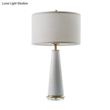 Modern White Fabric Cylinder Table Light With Cone Ceramic Base - 1 Bulb Desk Lamp