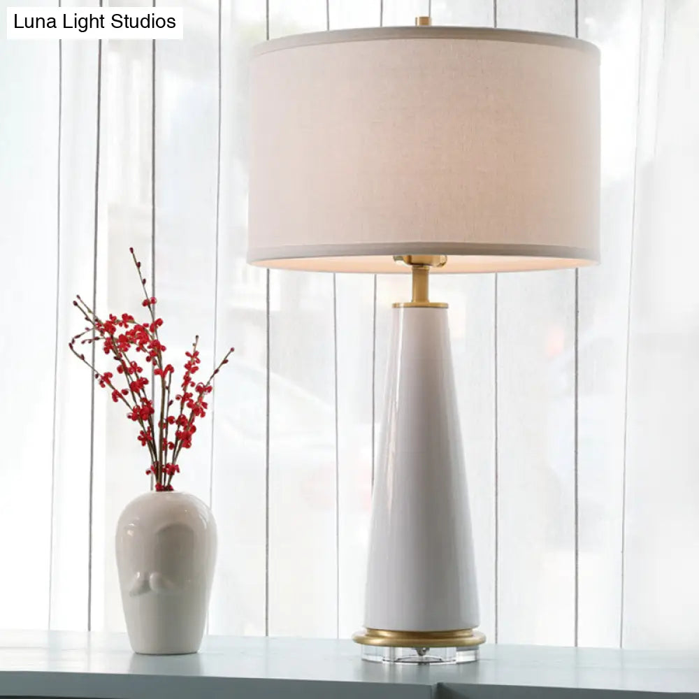 Modern White Fabric Cylinder Table Light With Cone Ceramic Base - 1 Bulb Desk Lamp