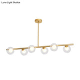 Nordic Metal 6-Head Linear Island Light With Gold Finish And Clear Glass Globes