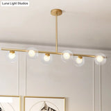 Nordic Metal 6-Head Linear Island Light With Gold Finish And Clear Glass Globes