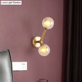 Novelty Amber Glass Wall Light Fixture With Rotatable Tree Crotch Accent - Modern 2-Bulb Gold Sconce