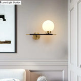 Post-Modern White Glass Sphere Wall Sconce With Brass Finish - 1/2 Bulbs