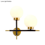 Post-Modern White Glass Sphere Wall Sconce With Brass Finish - 1/2 Bulbs