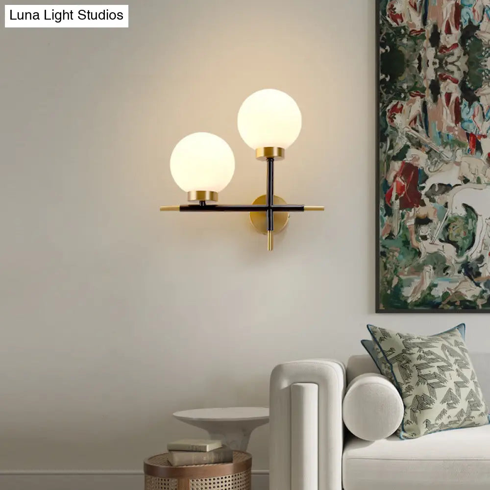 Post-Modern White Glass Sphere Wall Sconce With Brass Finish - 1/2 Bulbs