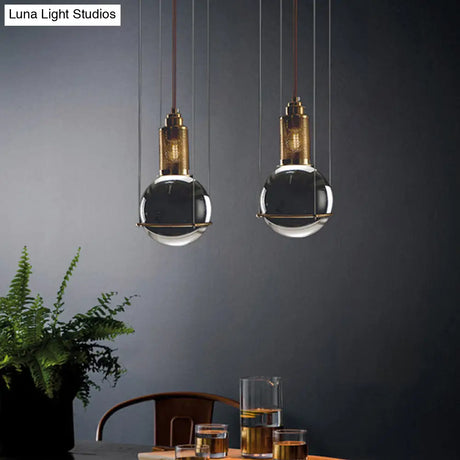 Postmodern Clear Glass Ball Pendant Ceiling Light With Gold Mesh Top - Single Hanging Lamp Kit