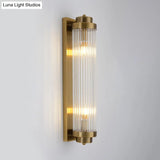 Postmodern Gold Wall Sconce With Clear Fluted Glass - 2 Lights Tubular Design