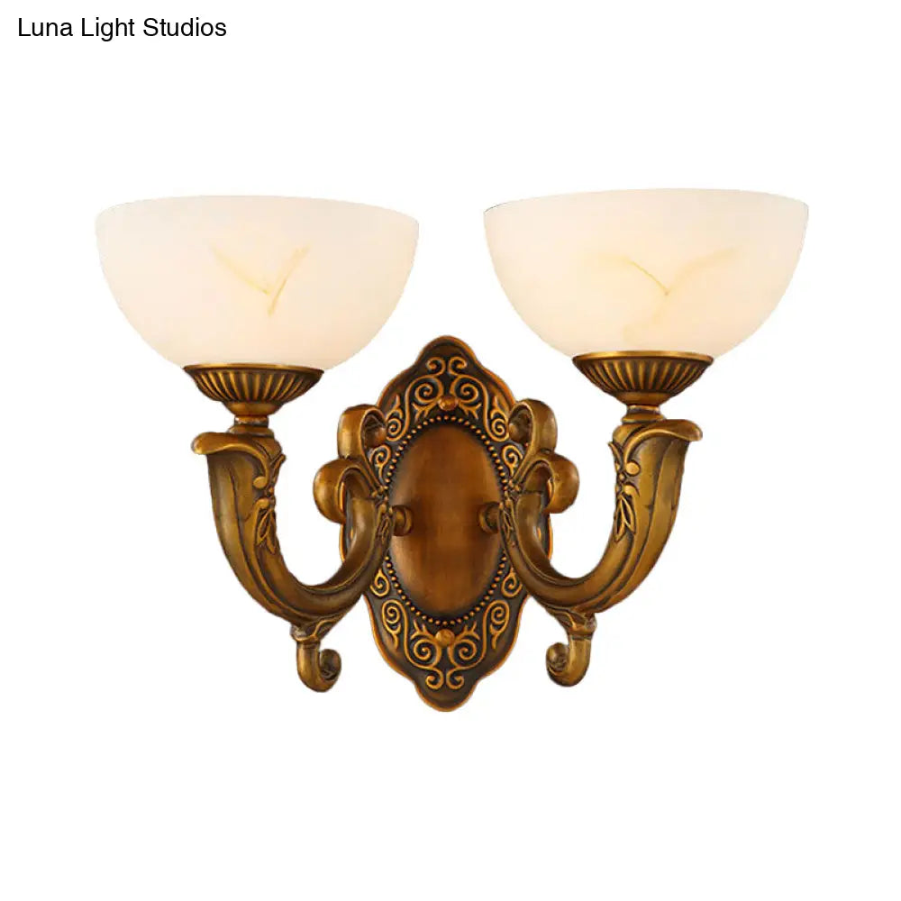Rustic Brass Wall Sconce With Frosted Glass Shade - Swooping Arm Design For Ambient Lighting