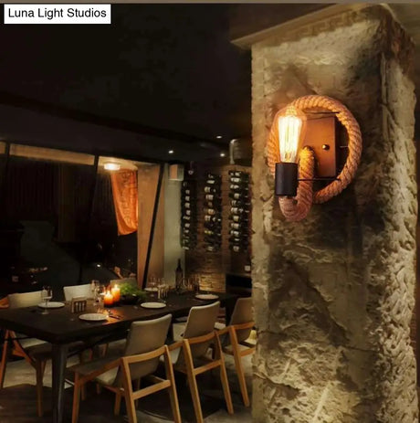 Rustic Indoor Wall Light With Wagon Wheel Design And Rope Shade