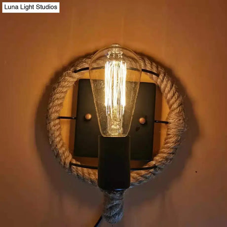 Rustic Indoor Wall Light With Wagon Wheel Design And Rope Shade