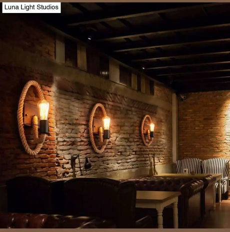 Rustic Indoor Wall Light With Wagon Wheel Design And Rope Shade