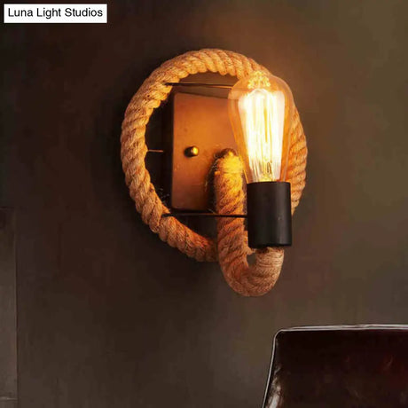 Rustic Indoor Wall Light With Wagon Wheel Design And Rope Shade