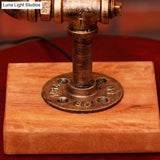 Rustic Wrought Iron Table Lamp With Stylish Open Bulb - Bedroom Lighting In Bronze
