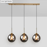 Sleek Glass 3-Bulb Brass Suspension Pendant Light For Minimalistic Dining Room Decor