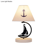 Sleek Mediterranean Metal Bedside Lamp In Black With White Fabric Shade