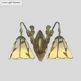 Tiffany Style Wall Sconce With Flared White/Beige Glass And Mermaid Backplate - 2 Light
