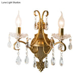 Traditional Crystal Candle Wall Sconce With Antiqued Brass Finish And Scroll Arm
