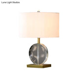Traditional Nightstand Lamp With White Fabric Cylinder Shade And Clear Circular Crystal Accent